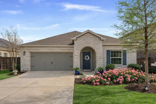 a front view of house with a garden