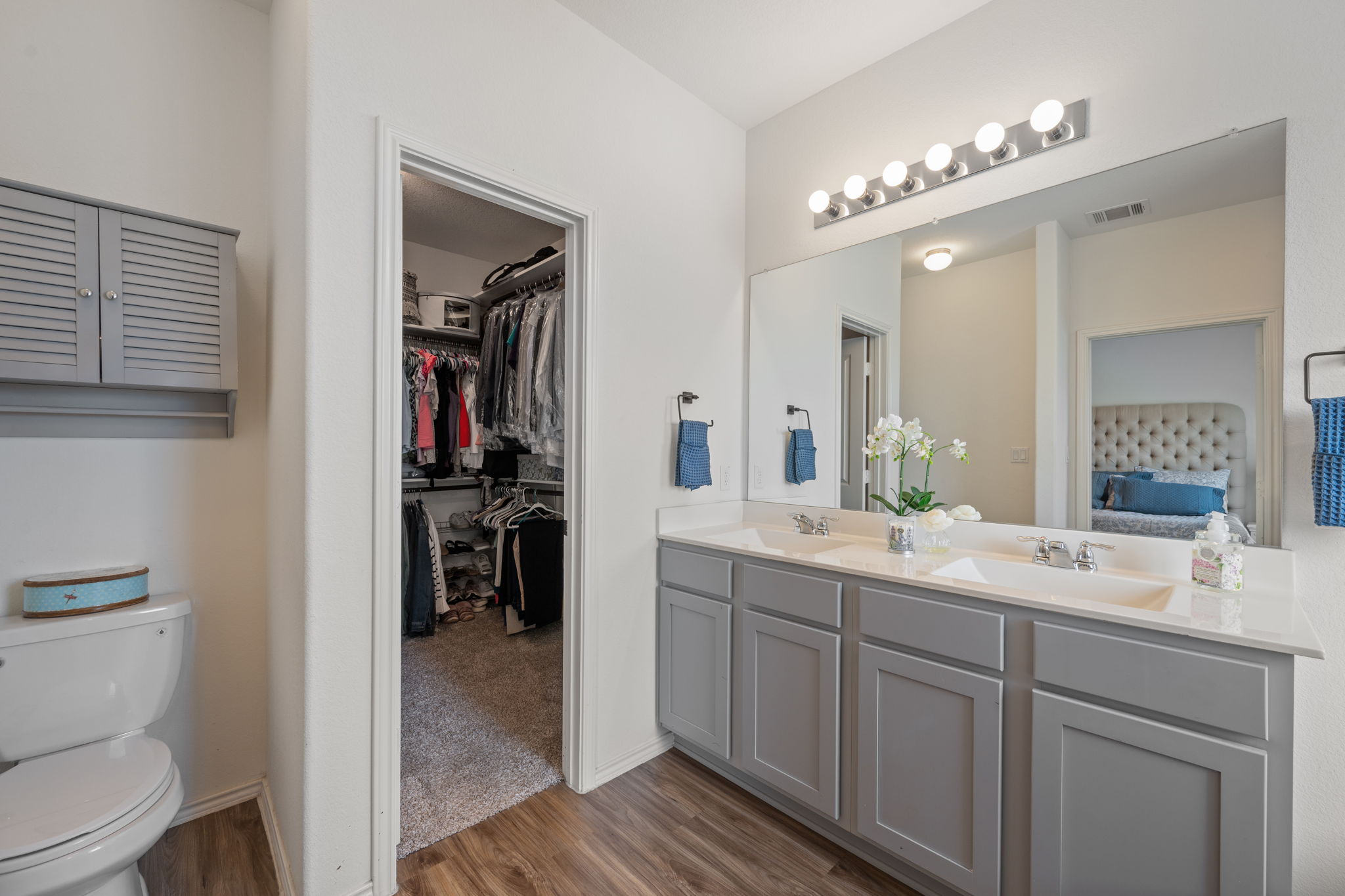 705 Mallow Road Leander, TX 78641 - Photo 16 of 29 a en suite bathroom with a toilet a sink and mirror