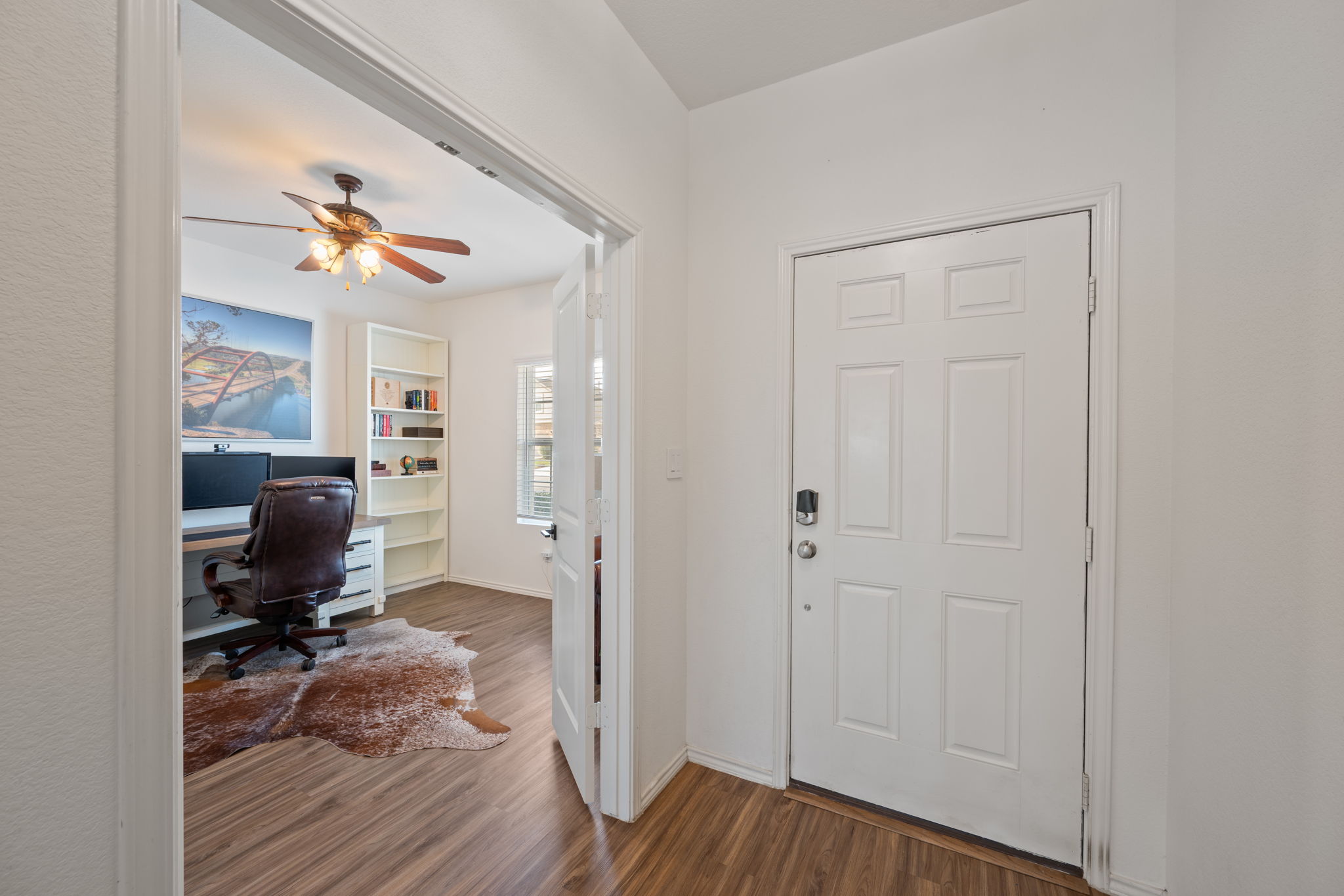 705 Mallow Road Leander, TX 78641 - Photo 17 of 29 a view of a workspace with furniture and wooden floor