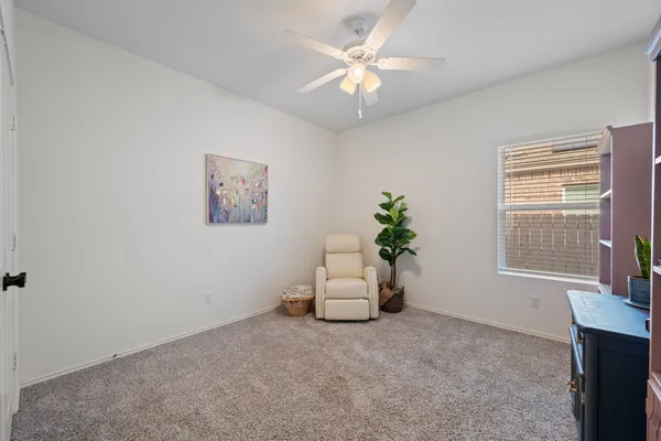 an empty room with windows and cabinet