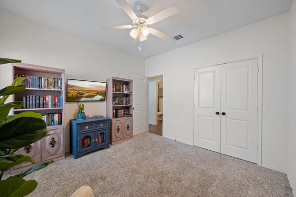 a living room with furniture and a bookshelf