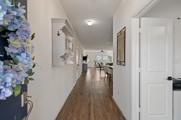 a view of a hallway with wooden floor