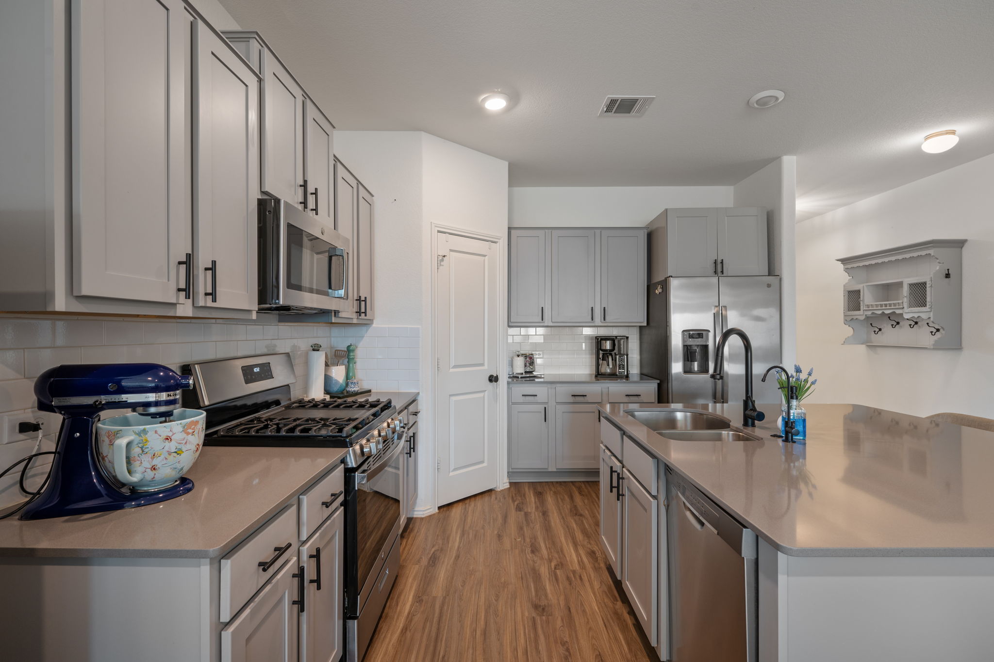 705 Mallow Road Leander, TX 78641 - Photo 8 of 29 a kitchen with stainless steel appliances granite countertop a sink stove and refrigerator