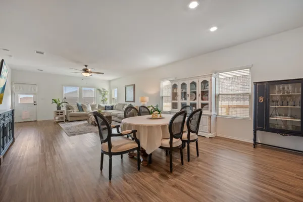 a view of a dining room with furniture and wooden floor