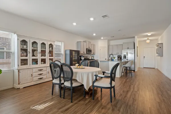 a view of a dining room with furniture and wooden floor
