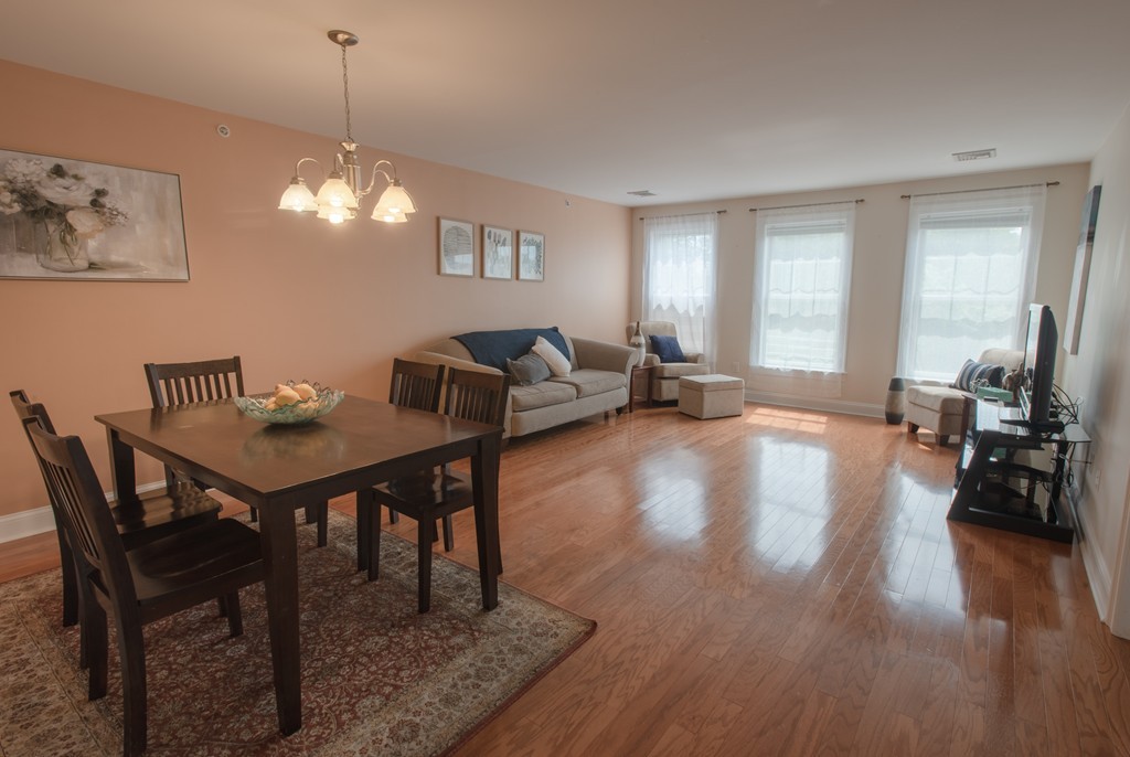 11 Cheriton Road, Unit 307 Boston, MA 02132 - Photo 2 of 12 a view of a dining room with furniture window and wooden floor