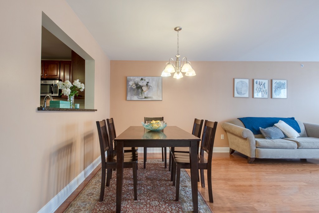 11 Cheriton Road, Unit 307 Boston, MA 02132 - Photo 3 of 12 a view of a dining room with furniture and chandelier