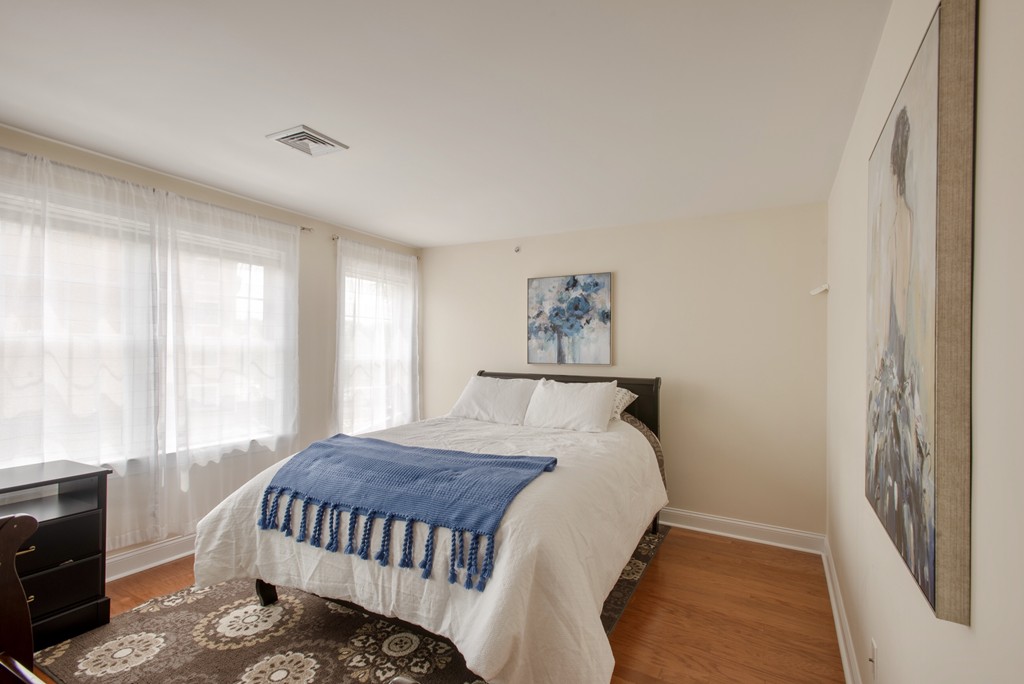11 Cheriton Road, Unit 307 Boston, MA 02132 - Photo 5 of 12 a bedroom with a bed and a window