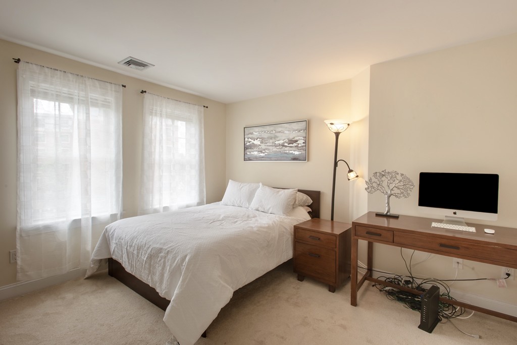 11 Cheriton Road, Unit 307 Boston, MA 02132 - Photo 6 of 12 a bedroom with a bed and a desk