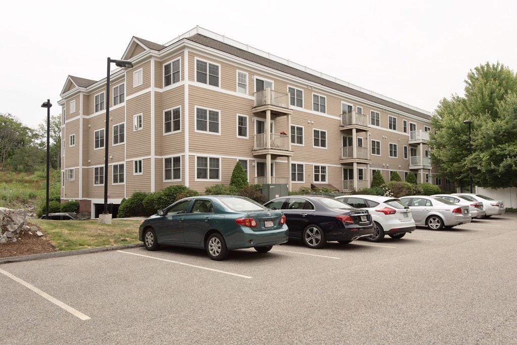 11 Cheriton Road, Unit 307 Boston, MA 02132 - Photo 10 of 12 a buildings with car parked in front of it