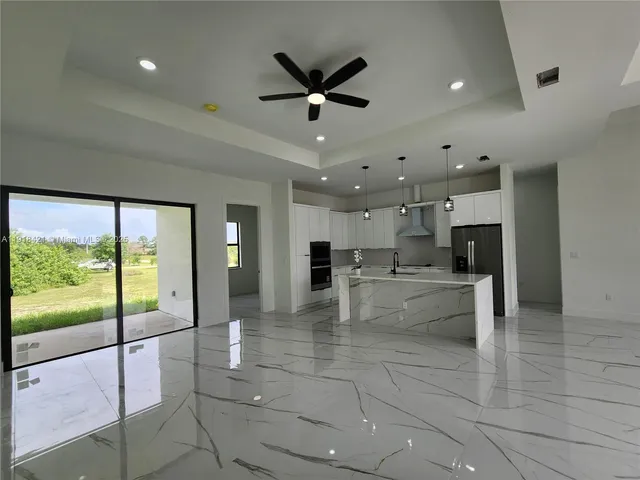 a kitchen with stainless steel appliances a refrigerator sink and stove