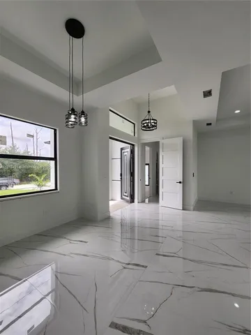 a view of a hallway with a chandelier
