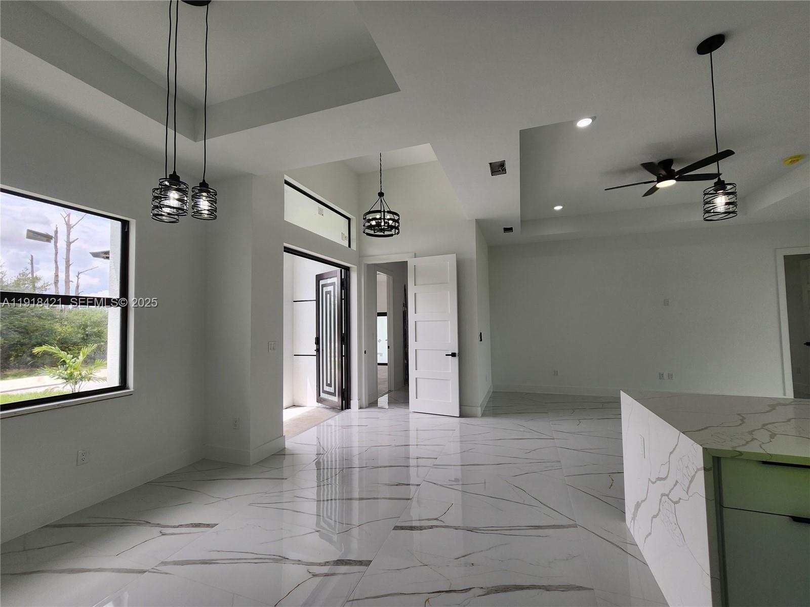 3302 East 18th Street, Unit ST Lehigh Acres, FL 33972 - Photo 15 of 34 a view of a hallway with a chandelier