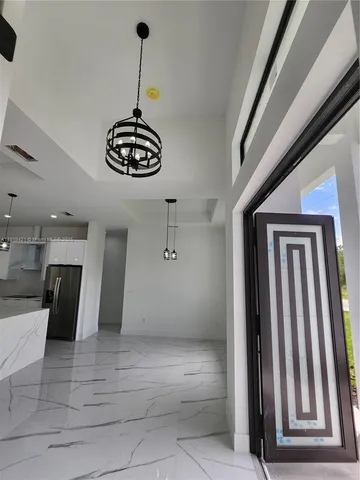 a kitchen with stainless steel appliances granite countertop a sink and cabinets with wooden floor