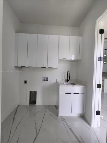 a view of a room with wooden floor and a ceiling fan
