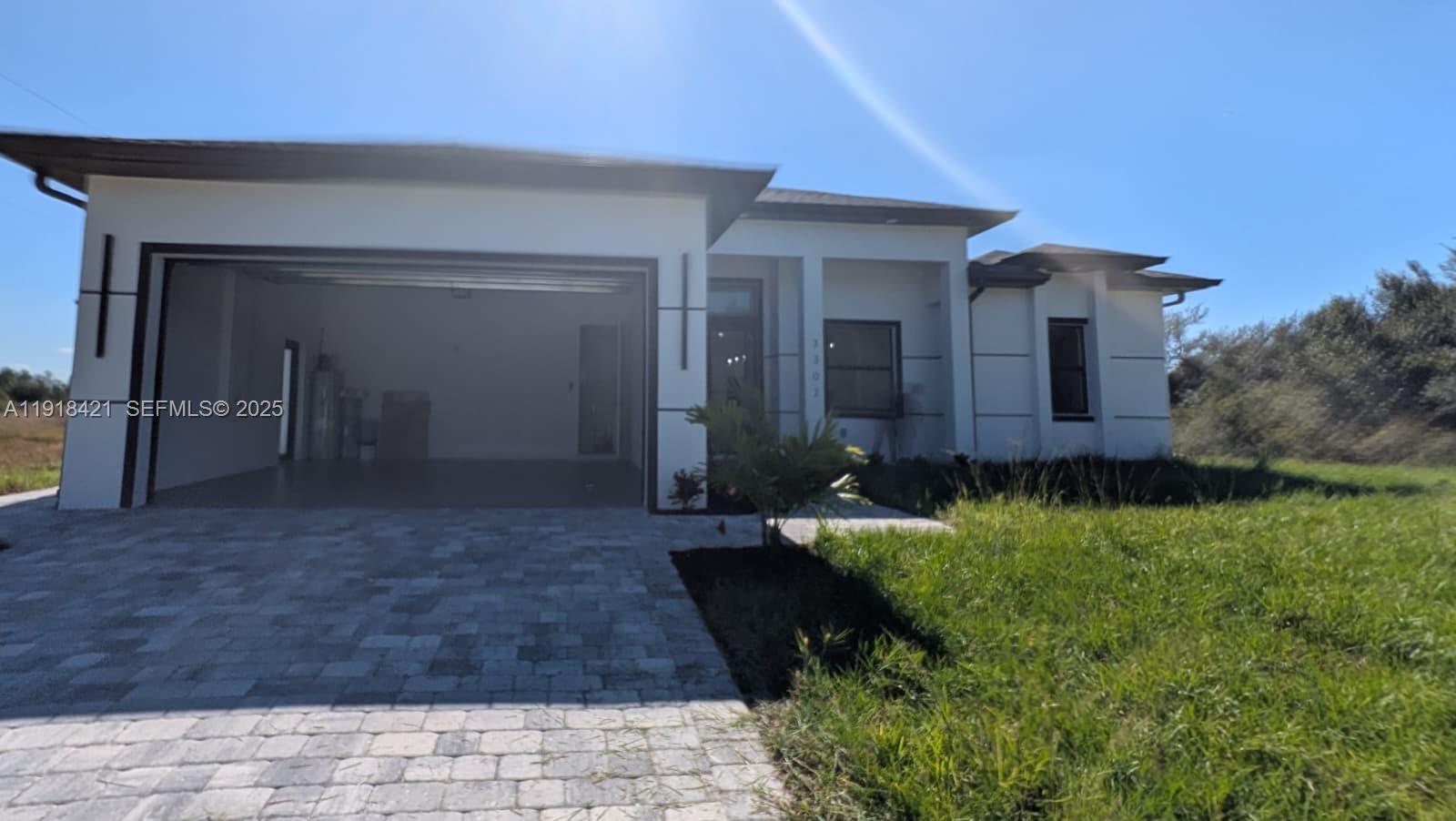 3302 East 18th Street, Unit ST Lehigh Acres, FL 33972 - Photo 2 of 34 a view of a house with brick walls