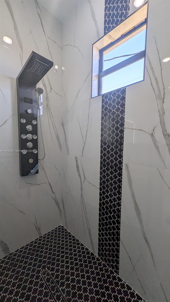 3302 East 18th Street, Unit ST Lehigh Acres, FL 33972 - Photo 23 of 34 a bathroom with a shower