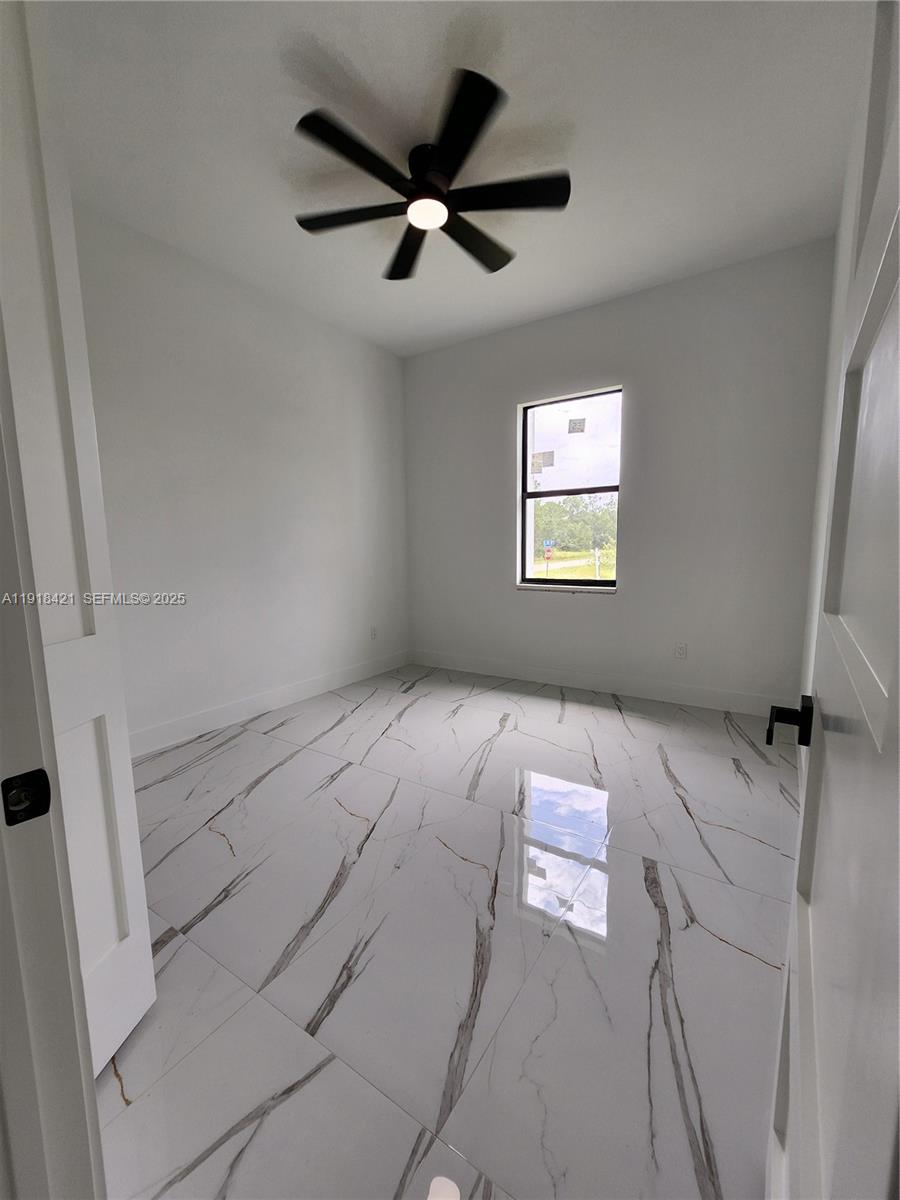3302 East 18th Street, Unit ST Lehigh Acres, FL 33972 - Photo 24 of 34 a view of an empty room and window