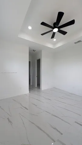 a bathroom with a granite countertop toilet sink and mirror