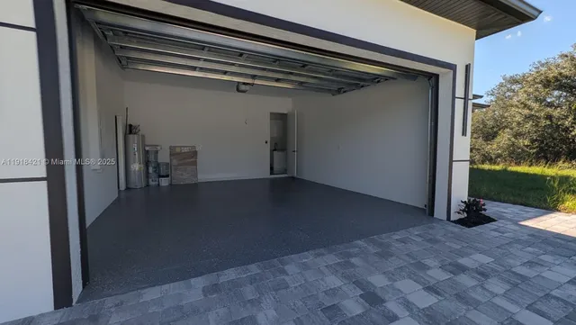 a kitchen with stainless steel appliances a refrigerator sink and microwave