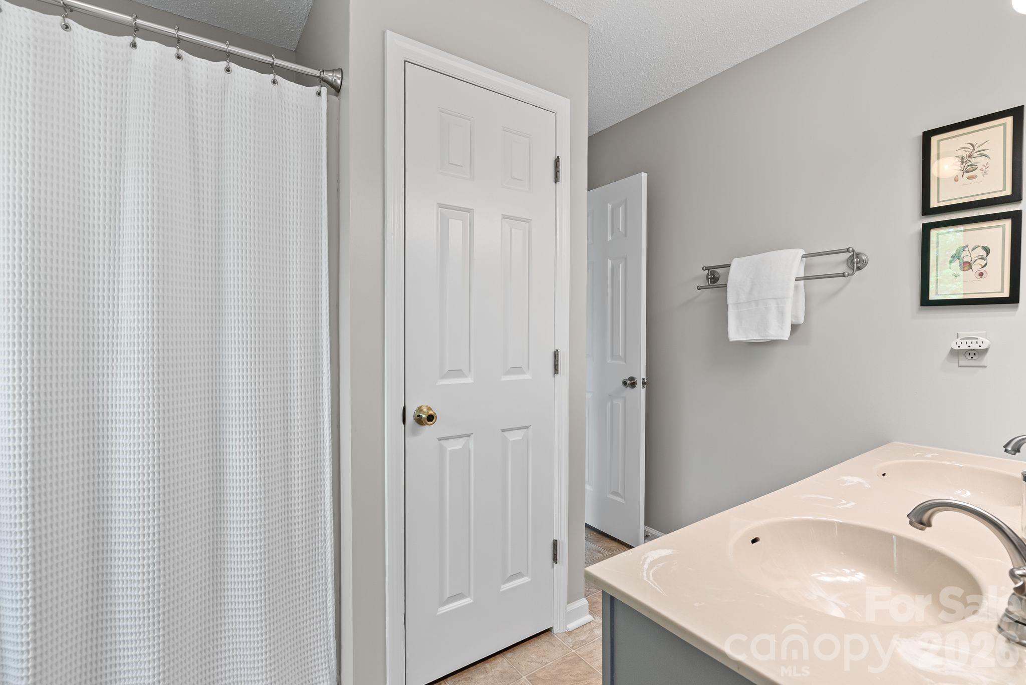 108 Kyfields Weaverville, NC 28787 - Photo 15 of 32 a bathroom with a granite countertop sink and a mirror