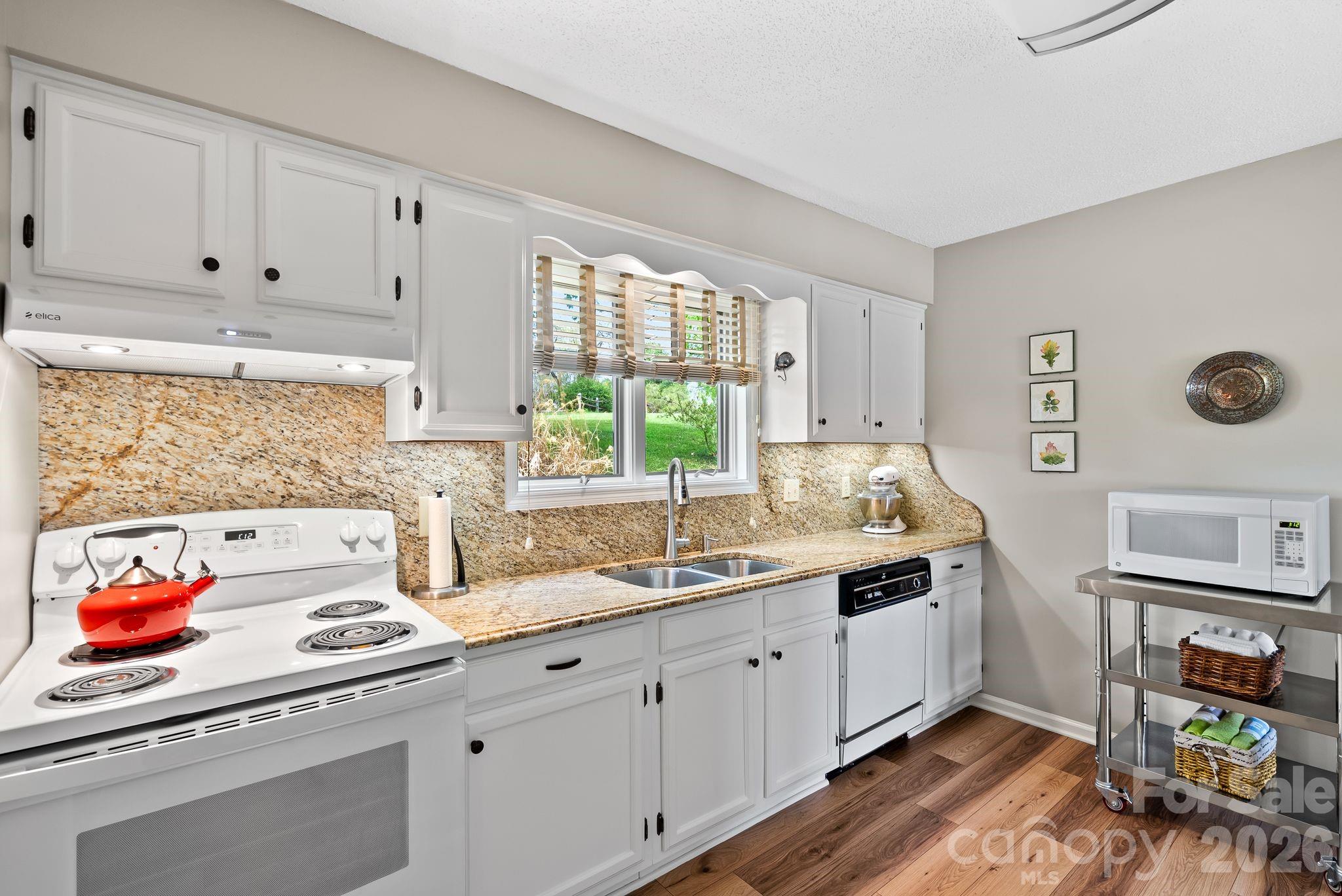 108 Kyfields Weaverville, NC 28787 - Photo 7 of 32 a kitchen with stainless steel appliances white cabinets and a window