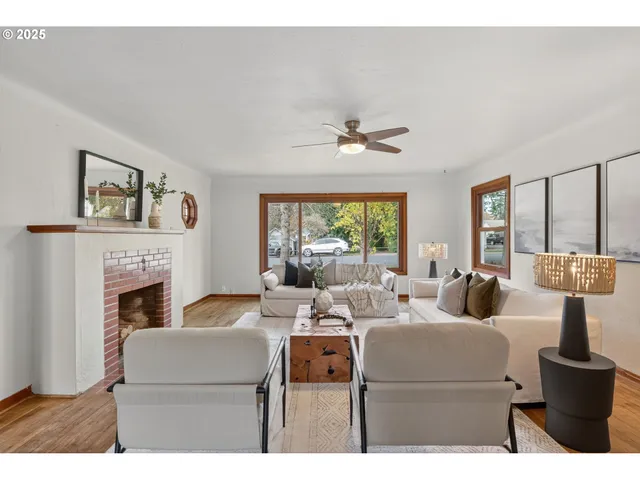 a living room with furniture a fireplace and a large mirror