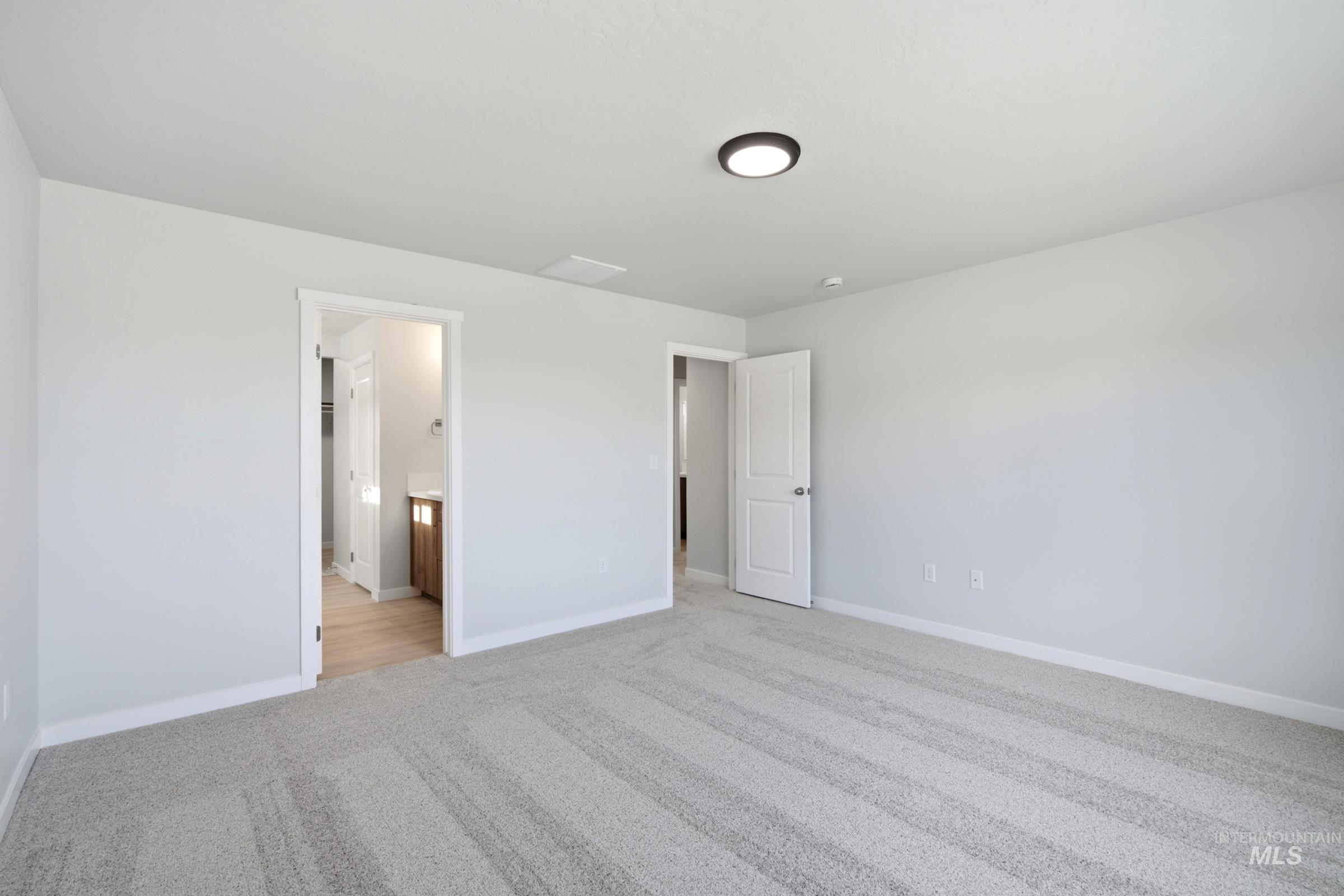 13324 Bank Street Caldwell, ID 83607 - Photo 26 of 29 Light gray wall paint, white trim, recessed lighting, and gray patterned carpet