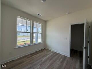 706 Old Station Angier, NC 27501 - Photo 11 of 19 a view of an empty room with wooden floor and a window