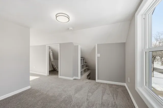 an empty room with windows and closet