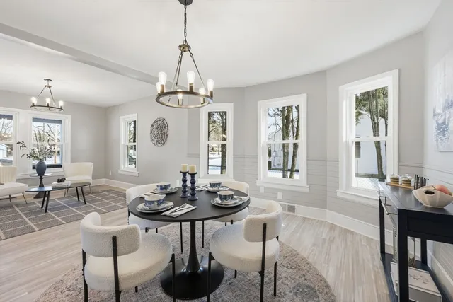 a view of a dining room with furniture window and wooden floor