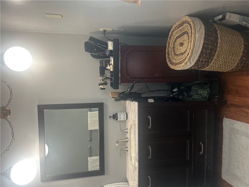 418 Saluda Road Williamston, SC 29697 - Photo 39 of 40 A well-appointed vanity with dark wood cabinetry and a framed mirror offers convenience.