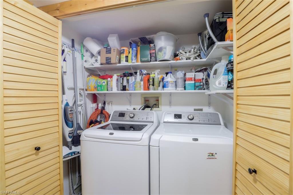1782 Imperial Golf Course Boulevard, Unit C104 Naples, FL 34110 - Photo 20 of 34 a utility room with dryer and washer