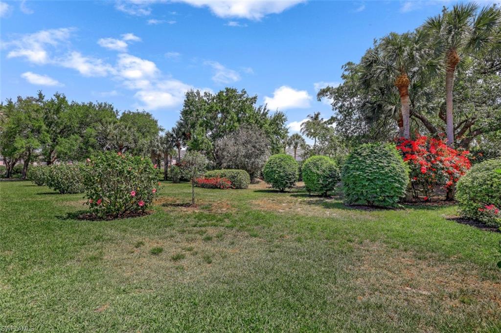 1782 Imperial Golf Course Boulevard, Unit C104 Naples, FL 34110 - Photo 25 of 34 a view of a garden with a house