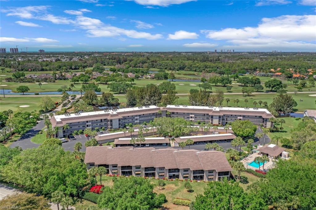 1782 Imperial Golf Course Boulevard, Unit C104 Naples, FL 34110 - Photo 31 of 34 an aerial view of house with yard swimming pool and lake view