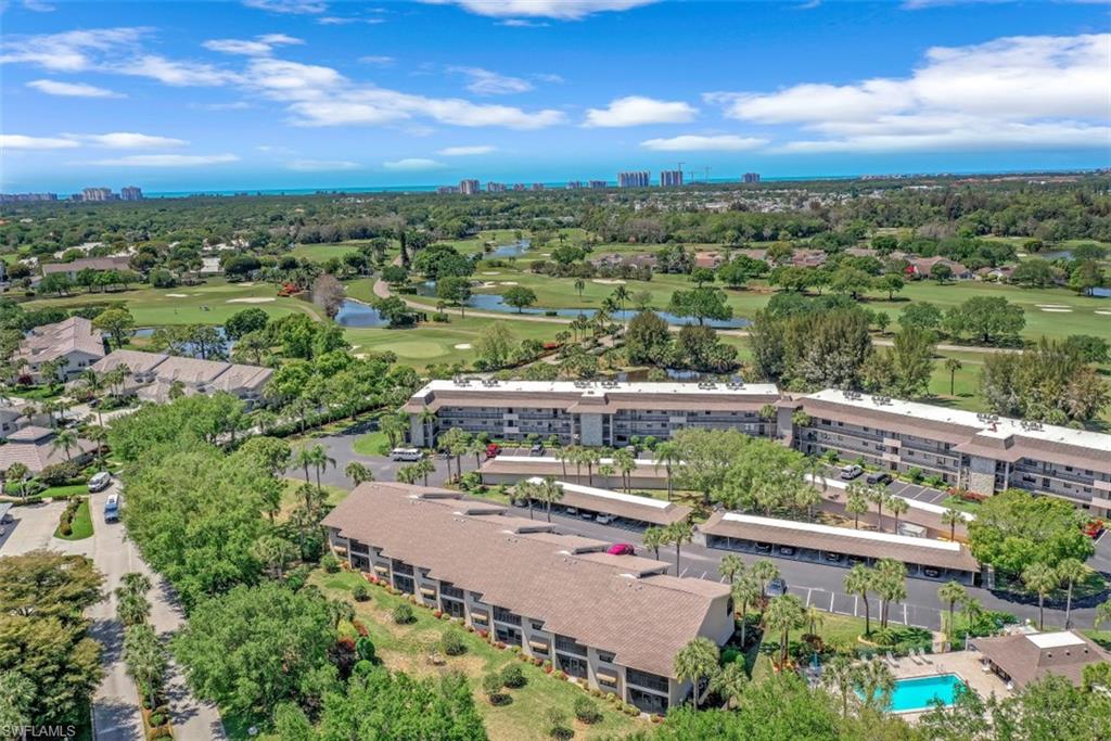 1782 Imperial Golf Course Boulevard, Unit C104 Naples, FL 34110 - Photo 32 of 34 an aerial view of a house with a lake view