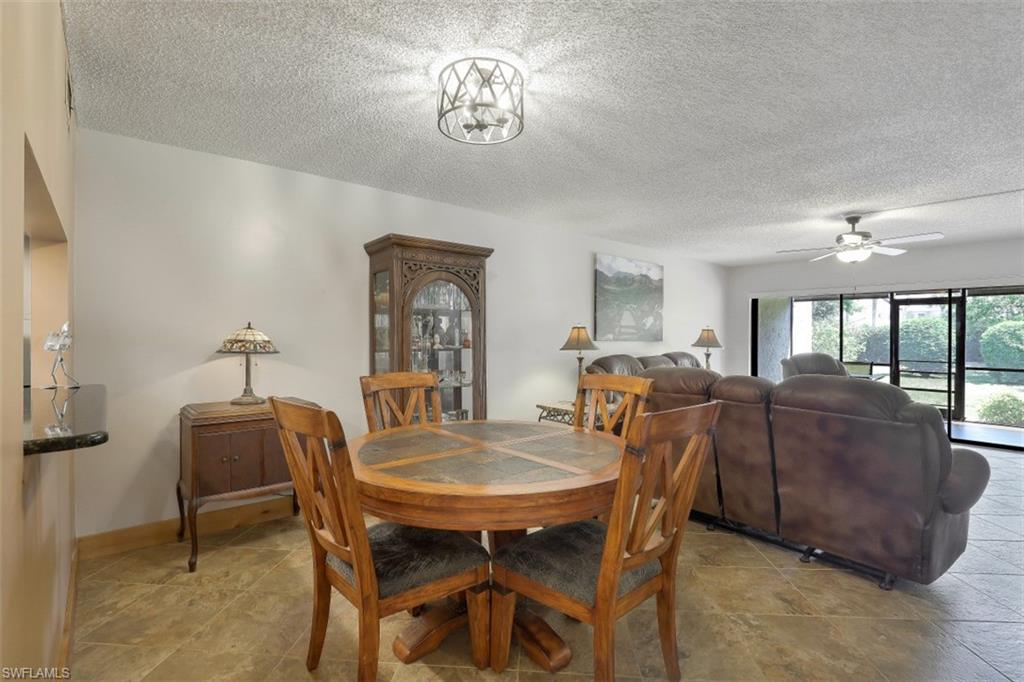 1782 Imperial Golf Course Boulevard, Unit C104 Naples, FL 34110 - Photo 5 of 34 a view of a dining room with furniture