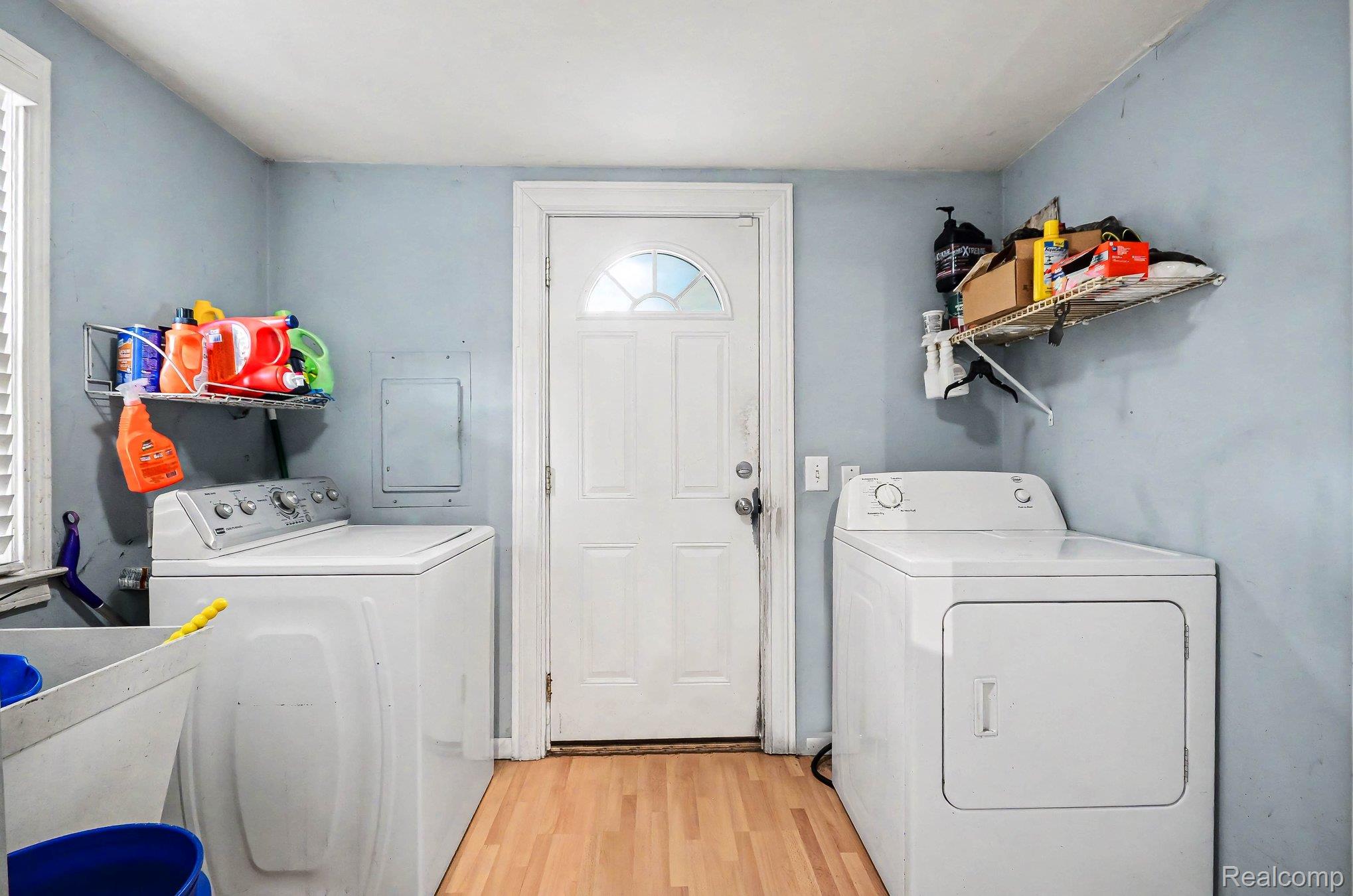 2126 Roslyn Road Grosse Pointe, MI 48236 - Photo 15 of 25 Laundry room with light wood-style floors, independent washer and dryer, and electric panel