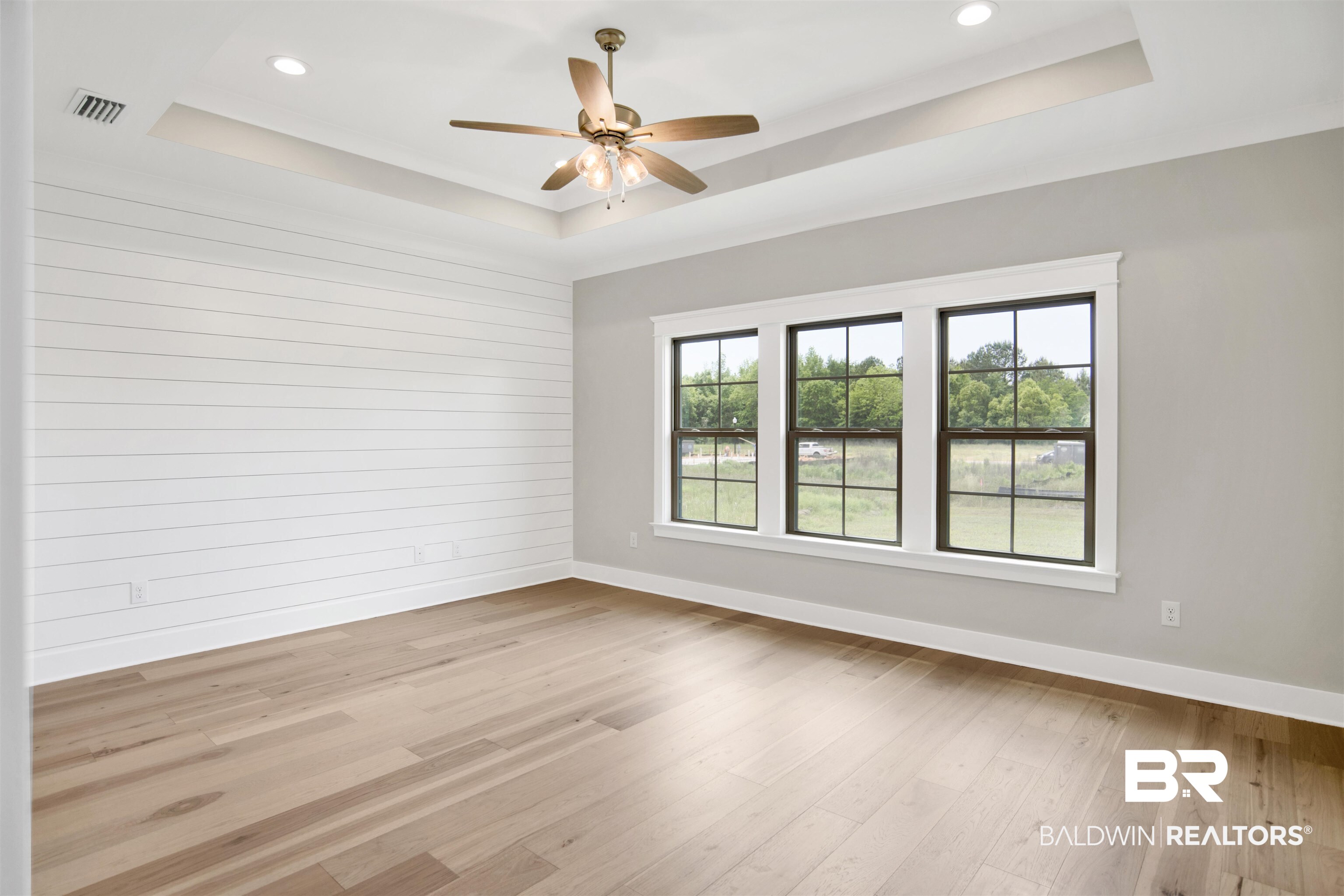 27331 Patch Pl Loop Daphne, AL 36526 - Photo 26 of 62 Primary bedroom featuring a healthy amount of natural light, a ceiling fan, light wood finished floors, recessed lighting, and a raised ceiling