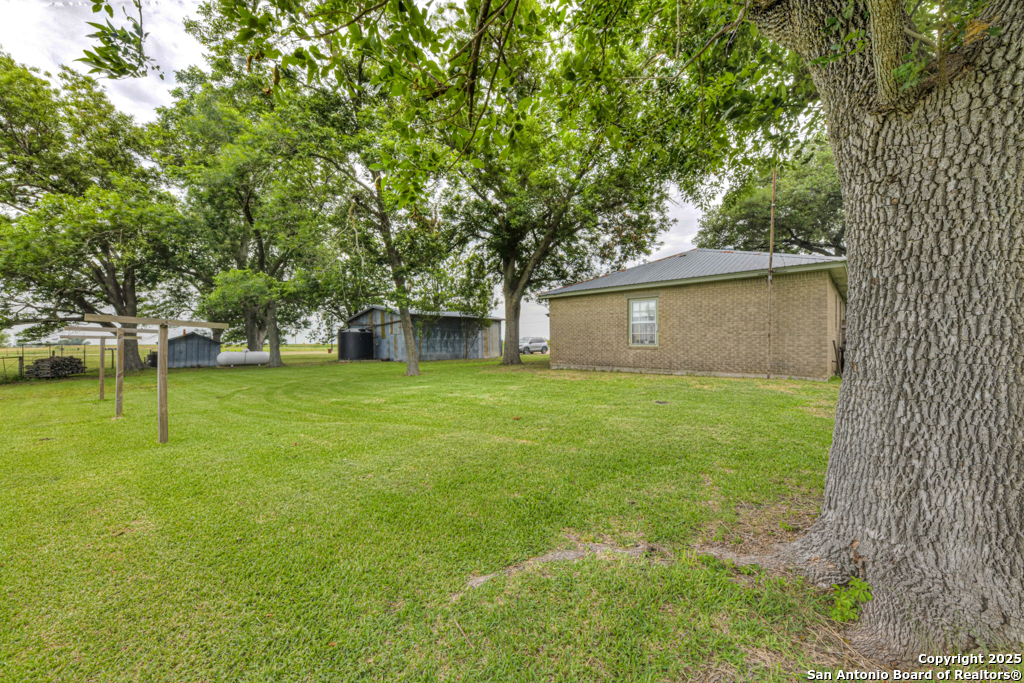 4190 Atkins Road Salado, TX 76571 - Photo 14 of 49 a backyard of a house with lots of green space