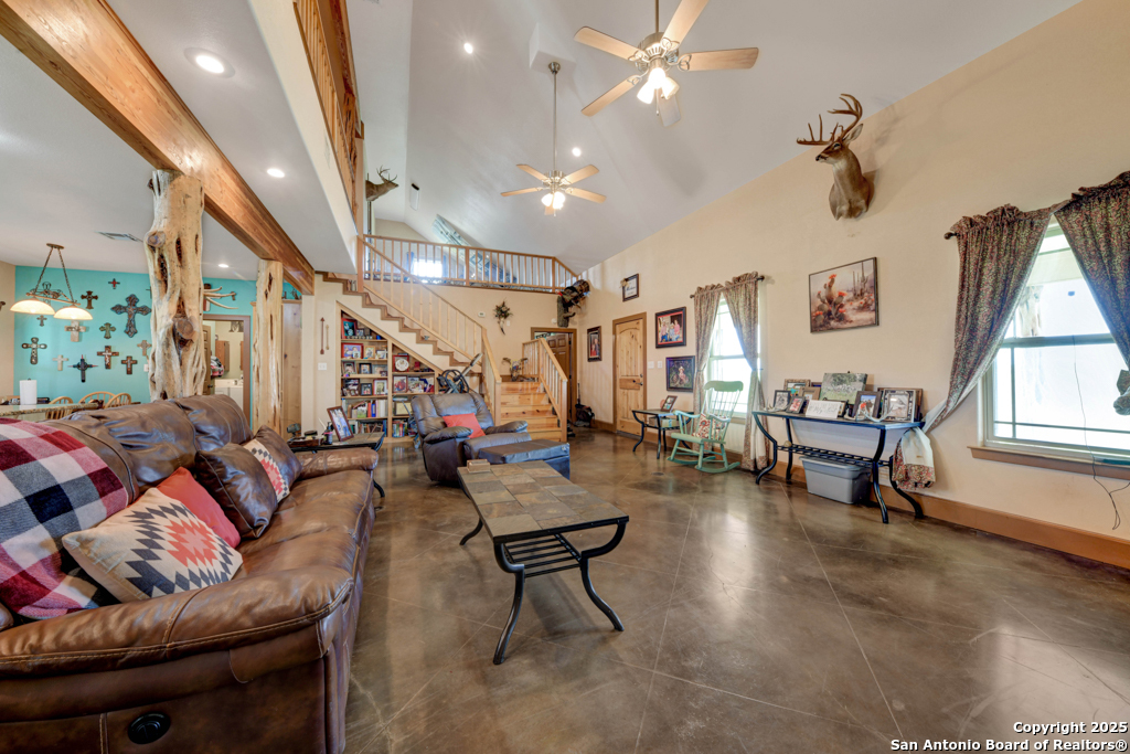 4190 Atkins Road Salado, TX 76571 - Photo 25 of 49 a living room with lots of furniture and a chandelier