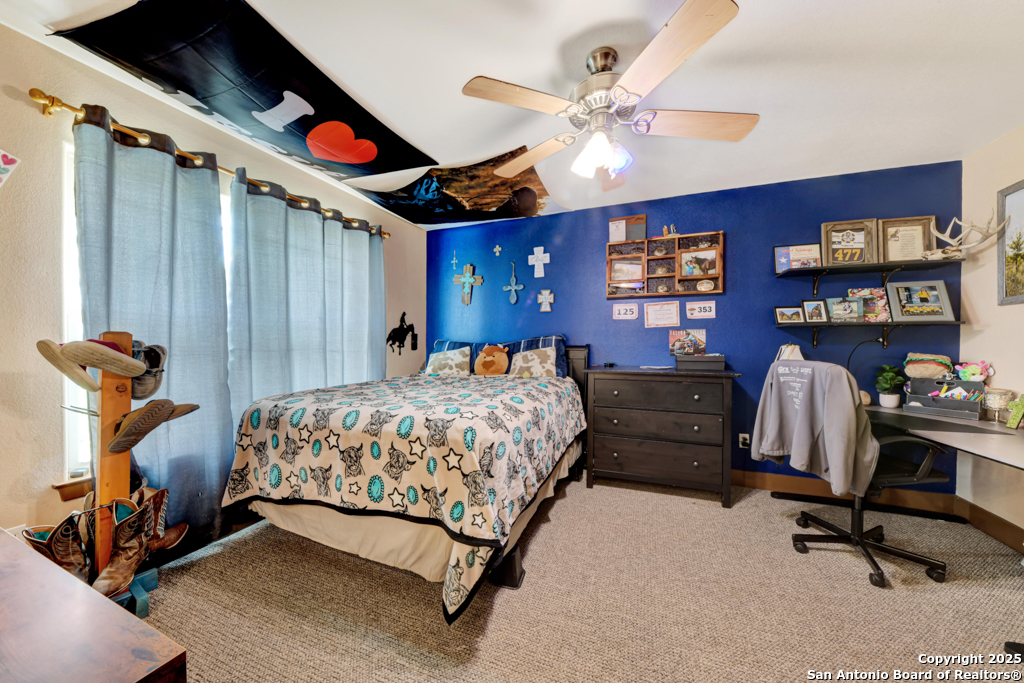 4190 Atkins Road Salado, TX 76571 - Photo 29 of 49 a bedroom with a bed gym equipment and a chandelier