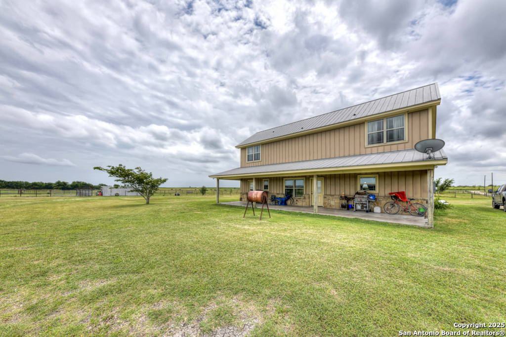 4190 Atkins Road Salado, TX 76571 - Photo 31 of 49 a view of a swimming pool with lawn chairs and a big yard