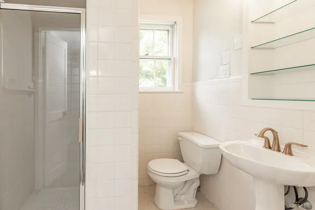 a white toilet sitting next to a bathroom sink