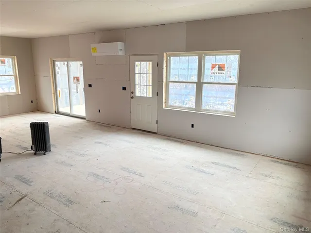 a view of an empty room with windows