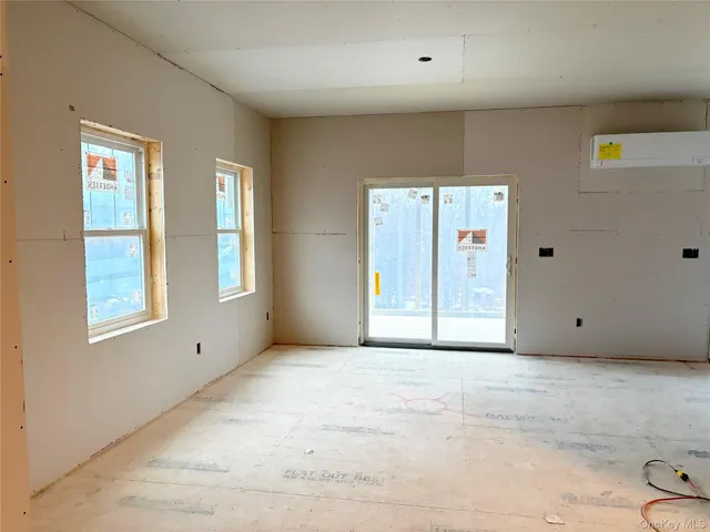 a view of a room with gym equipment and a window