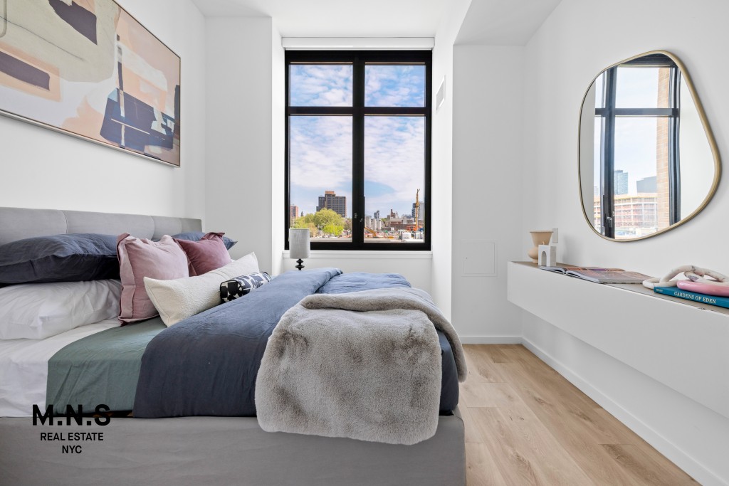 500 Degraw Street, Unit 2109 Brooklyn, NY 11217 - Photo 10 of 23 a spacious bedroom with a bed a mirror and a large window