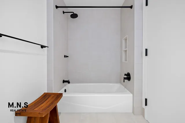a bathroom with a bathtub and a shower