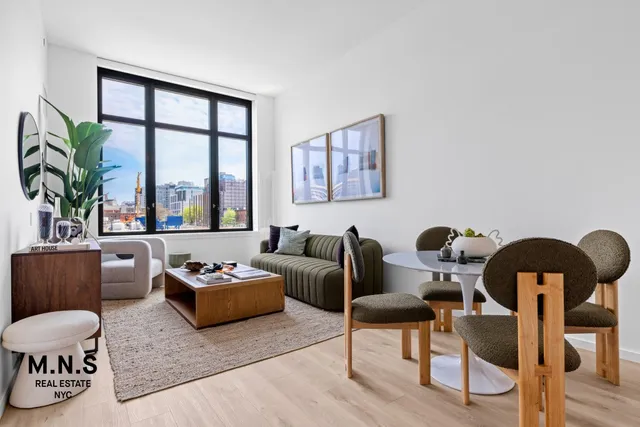 a living room with furniture and a large window with wooden floor