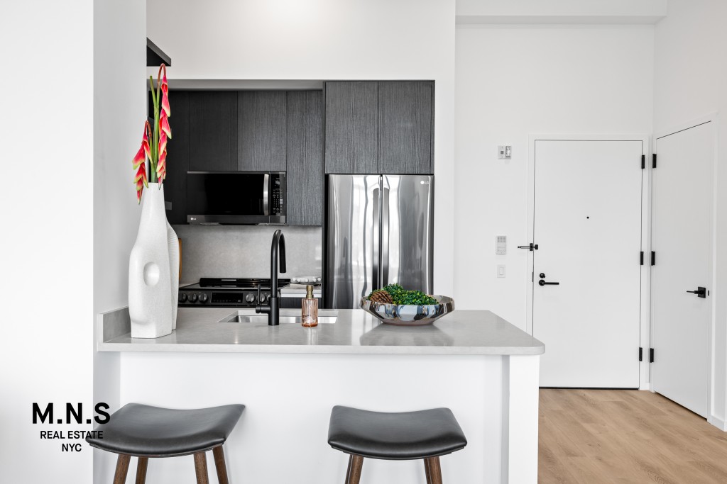 500 Degraw Street, Unit 2109 Brooklyn, NY 11217 - Photo 7 of 23 a kitchen with stainless steel appliances a dining table and chairs